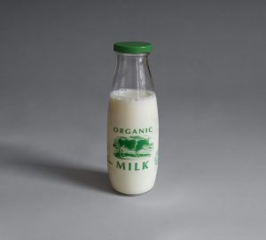 a bottle of organic milk sitting on a table