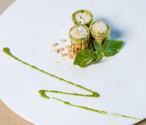 green and white sliced vegetables on white ceramic plate