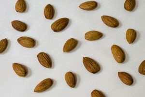 brown almond nut on white surface
