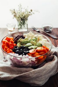 a glass bowl filled with different types of vegetables